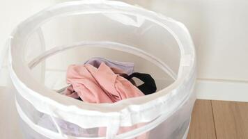 Old clothes thrown into the trash can. Disposal and recycling of clothes. video