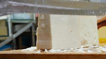 Worker slicing the cheese on table , video