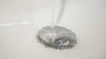 water pouring from a faucet tap slow motion video