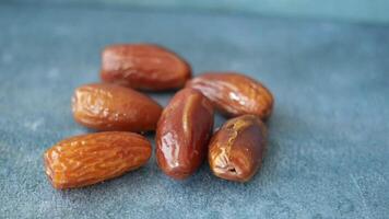 slow motion of fresh date fruit dropping on a table video