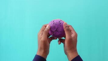 hand cracking a chocolate donuts top view video