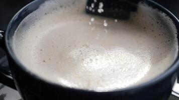 slow motion of dropping sugar in a coffee cup , video