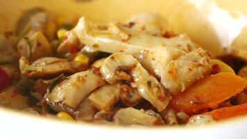 a bowl with field salad and roasted mushrooms. video