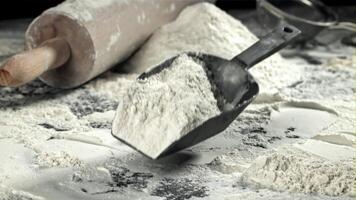 Flour falls on the kitchen table. Filmed on a high-speed camera at 1000 fps. High quality FullHD footage video