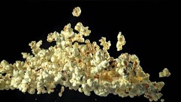 Popcorn flies up and falls down. On a black background. Filmed on a high-speed camera at 1000 fps. High quality FullHD footage video