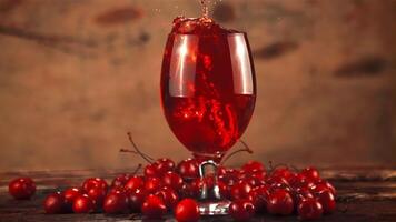 Super slow motion in a glass with cherry juice drops fresh cherry. On a brown background.Filmed on a high-speed camera at 1000 fps. video