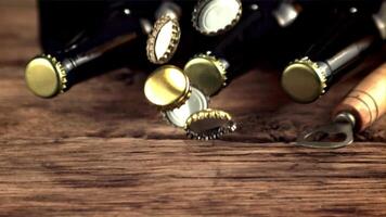 Super slow motion beer lids fall on the table and rotate. On a wooden background.Filmed on a high-speed camera at 1000 fps. video