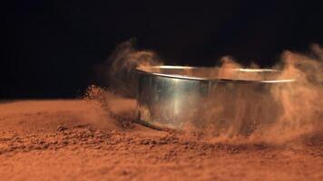 Super slow motion sieve falls on the cocoa with dust. On a brown background. Filmed on a high-speed camera at 1000 fps.High quality FullHD footage video