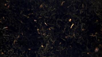 Super slow motion dry fragrant tea takes off. Macro background.Filmed on a high-speed camera at 1000 fps. High quality FullHD footage video