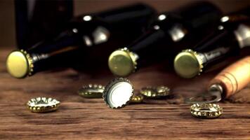 Super slow motion lids from beer bottles fall on the table. On a wooden background.Filmed on a high-speed camera at 1000 fps. video