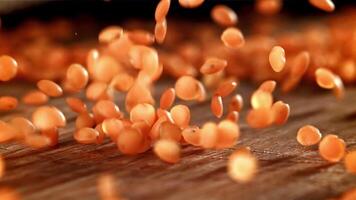 Lentils fall on a wooden plank. Filmed on a high-speed camera at 1000 fps. High quality FullHD footage video