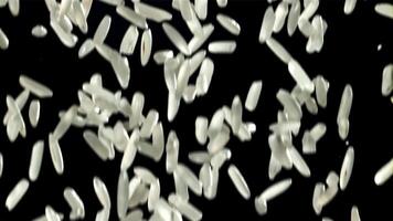 Grains of rice falling on black background. Filmed on a high-speed camera at 1000 fps. High quality FullHD footage video