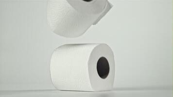 Toilet paper falling on the table on a white background. Filmed on a high-speed camera at 1000 fps. High quality FullHD footage video