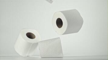 Toilet paper falling on the table on a white background. Filmed on a high-speed camera at 1000 fps. High quality FullHD footage video