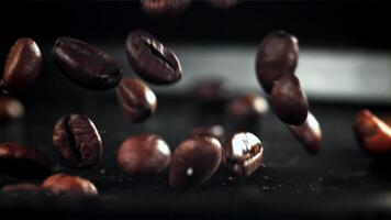 Coffee beans fall on the table. Filmed on a high-speed camera at 1000 fps. High quality FullHD footage video