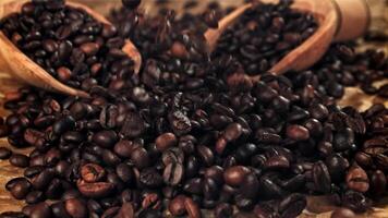 Coffee beans fall on the table. Filmed on a high-speed camera at 1000 fps. High quality FullHD footage video