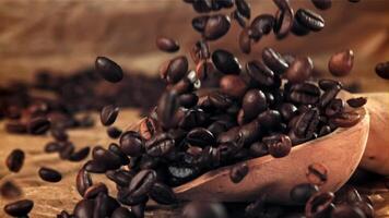 Coffee beans fall into a scoop. Filmed on a high-speed camera at 1000 fps. High quality FullHD footage video