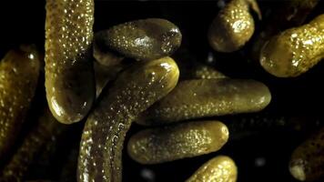 Pickled cucumbers fly up and fall down. Filmed on a high-speed camera at 1000 fps. High quality FullHD footage video