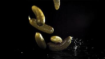 Pickled cucumbers fall with splashes. Filmed on a high-speed camera at 1000 fps. High quality FullHD footage video