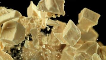 Pieces of white chocolate fly up and fall down. Filmed on a high-speed camera at 1000 fps. High quality FullHD footage video