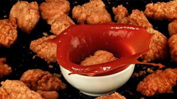 Nuggets fall into ketchup. Filmed is slow motion 1000 fps. High quality FullHD footage video