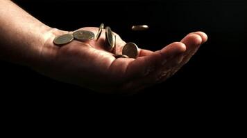 Coins fall into hand. Filmed is slow motion 1000 fps. High quality FullHD footage video