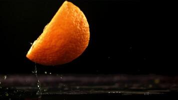 Orange slices fall on the table. Filmed is slow motion 1000 fps. High quality FullHD footage video