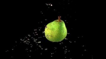 Super slow motion is one green pear under water with air bubbles. On a black background. Filmed on a high-speed camera at 1000 fps. High quality FullHD footage video