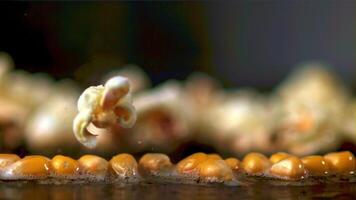 Super slow motion popcorn grains explode. Macro background.Filmed on a high-speed camera at 1000 fps. High quality FullHD footage video