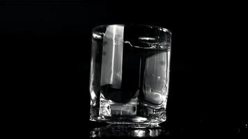 Super slow motion of the glass of water falls on the table. On a black background.Filmed on a high-speed camera at 1000 fps. video