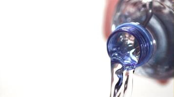 Super slow motion from the bottle pours a stream of water. On a white background. Filmed at 1000 fps. video