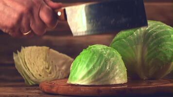 Super slow motion cabbage is chopped with a knife on a cutting board.Filmed at 1000 fps. On a wooden background. video