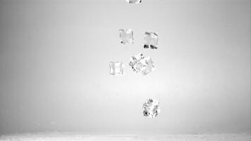 Super slow motion ice cubes fall on the table. On a gray background. Filmed on a high-speed camera at 1000 fps. video