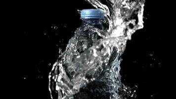 Super slow motion of the jet of water falls on the water bottle. Filmed on a high-speed camera at 1000 fps.On a black background. video