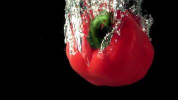 Super slow motion red bell pepper falls under the water with air bubbles. On a black background.Filmed on a high-speed camera at 1000 fps. video