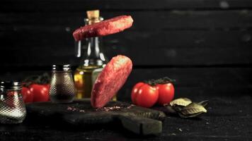 Super slow motion on the cutting board falls raw burger. On a black background.Filmed on a high-speed camera at 1000 fps. video