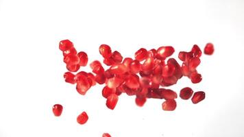 Super slow motion grain pomegranate rise up. On a white background. Filmed on a high-speed camera at 1000 fps. High quality FullHD footage video