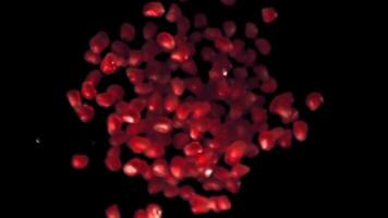 Super slow motion of the grain of ripe pomegranate. On a black background. Filmed on a high-speed camera at 1000 fps. High quality FullHD footage video