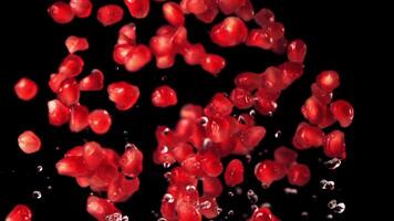 Super slow motion of the grain of ripe pomegranate. On a black background. Filmed on a high-speed camera at 1000 fps. High quality FullHD footage video