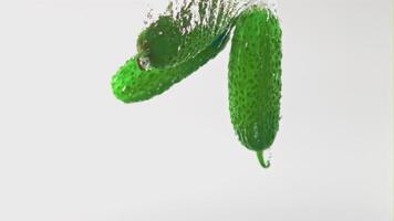 Super slow movement of cucumbers under water with air bubbles. On a white background.Filmed on a high-speed camera at 1000 fps. High quality FullHD footage video