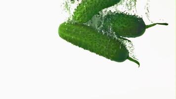 Super slow movement of cucumbers under water with air bubbles. On a white background.Filmed on a high-speed camera at 1000 fps. High quality FullHD footage video