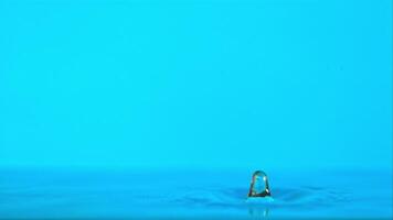 Super slow motion of the water drop falls on the blue background. Filmed on a high-speed camera at 1000 fps. High quality FullHD footage video