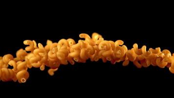 Super slow motion pasta cavatappi dry. On a black background. Filmed on a high-speed camera at 1000 fps. High quality FullHD footage video