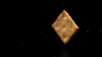 Super slow motion cracker falls on the table. On a black background.Filmed on a high-speed camera at 1000 fps. High quality FullHD footage video