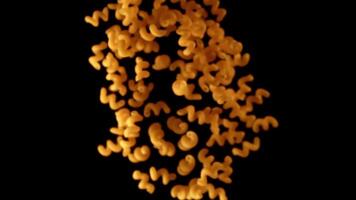 Super slow motion pasta cavatappi dry. On a black background. Filmed on a high-speed camera at 1000 fps. High quality FullHD footage video