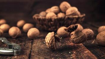 The super slow motion of the walnut splits against the table. On a wooden background. Filmed on a high-speed camera at 1000 fps. video