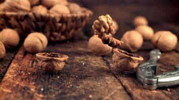 Super slow motion on the table falls walnut and splits. On a wooden background. Filmed on a high-speed camera at 1000 fps. video