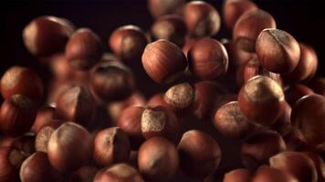 Super slow motion hazelnuts rise up and fall down. On a black background.Filmed on a high-speed camera at 1000 fps. video