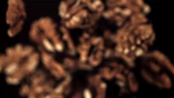 Super slow motion peeled walnuts rise up and fall. On a black background.Filmed on a high-speed camera at 1000 fps. video