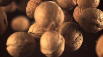 Super slow motion walnuts soar up and fall down. On a black background.Filmed on a high-speed camera at 1000 fps. video